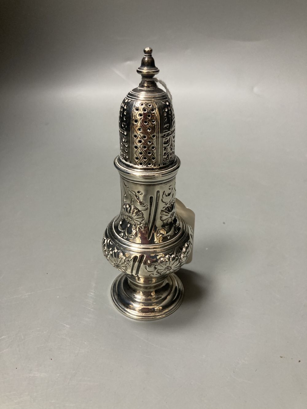 An early George III silver pepperette, with later embossed decoration, Samuel Wood?, London, 1760, 13.9cm, 111 grams.